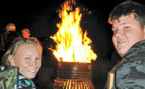 Aleisha Smith and Shane Pettiford sit by a fire drum at the bonfire night. Aleisha Smith and Shane Pettiford sit by a fire drum at the bonfire night.